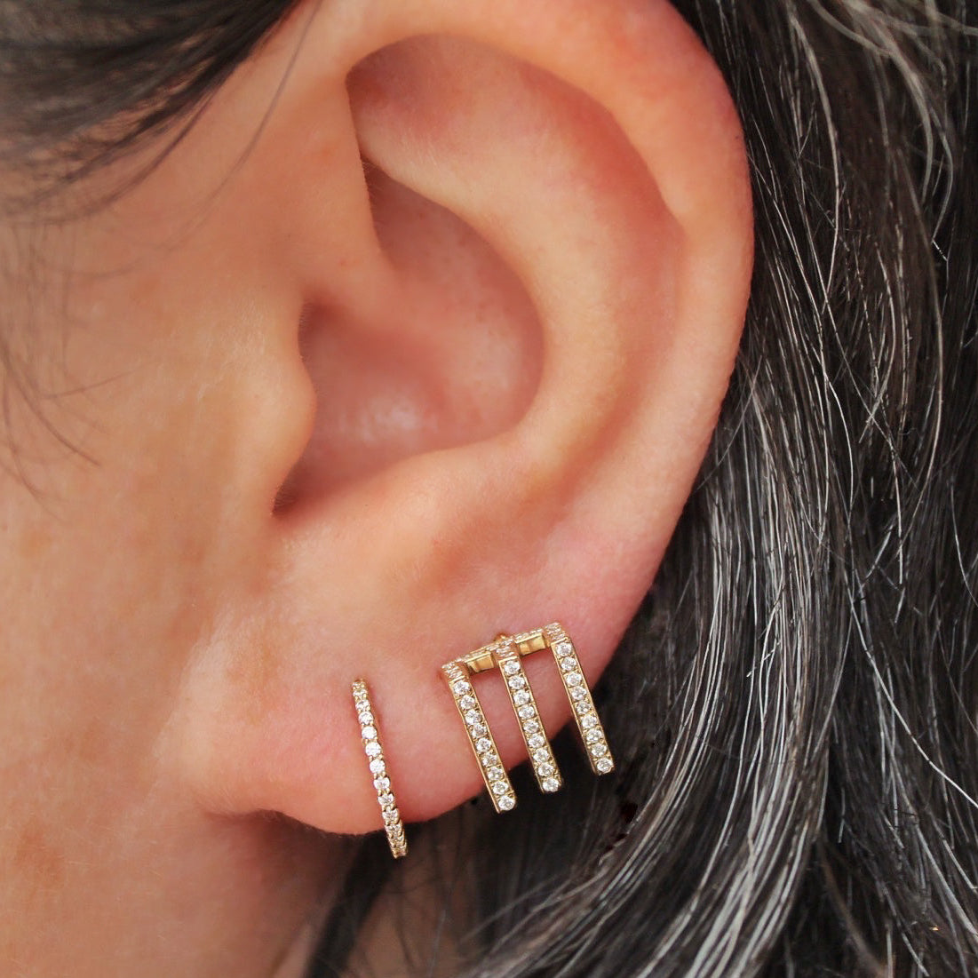 Left ear with two lobe piercings featuring Yellow Gold Hoops. Jewelry Stud. Yellow Gold. Earring. Cartilage Earring. Nostril jewelry. Gold Jewelry. BVLA. Body Vision Los Angeles Jewelry. Brooklyn Piercing Jewelry