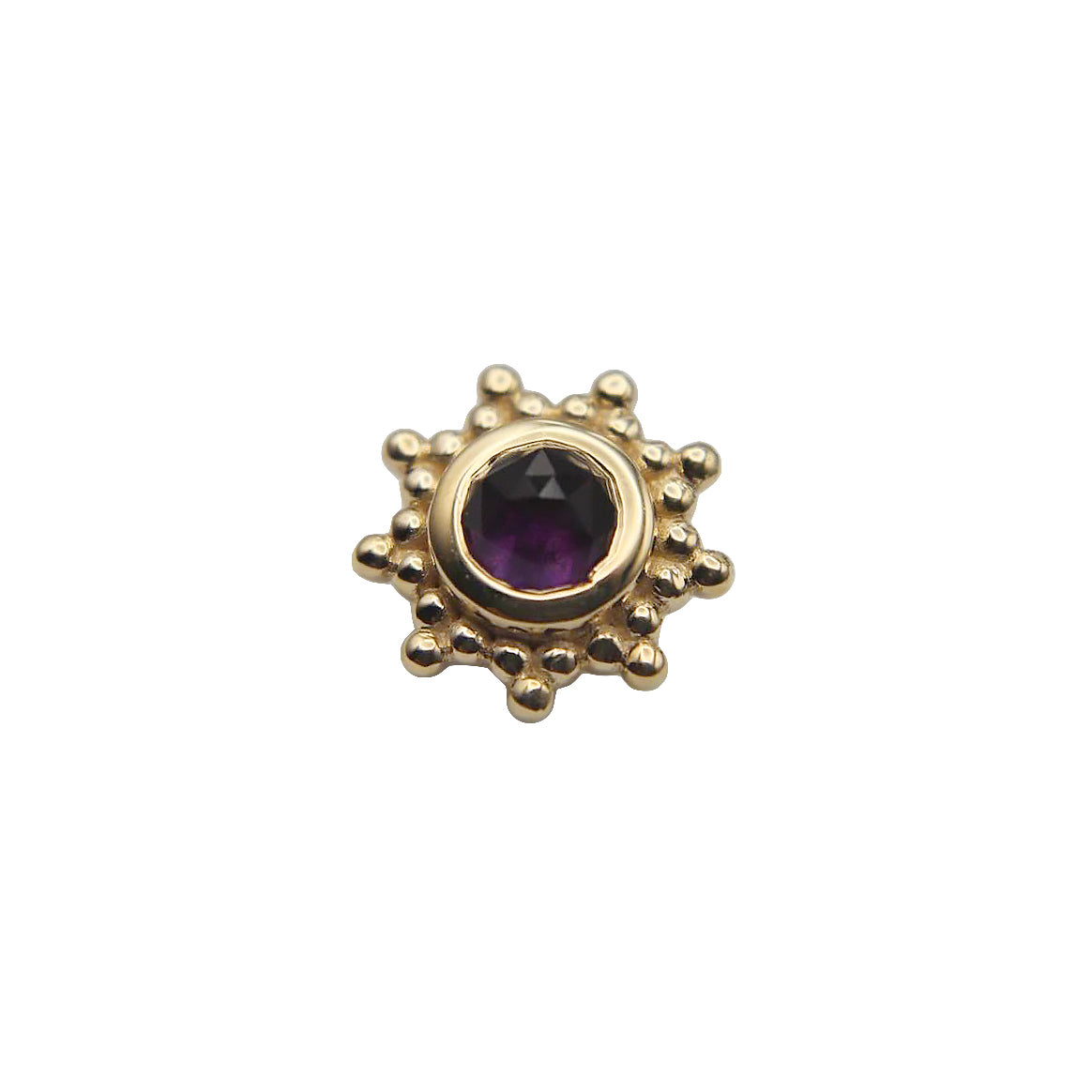 Gold sun-shaped stud with a central amethyst gemstone on a white background