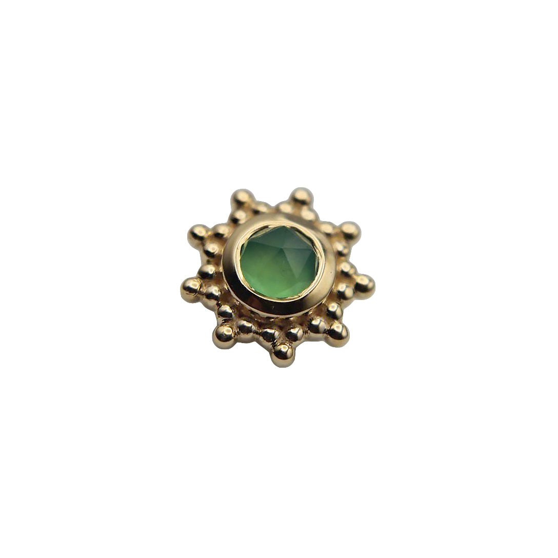 Gold sun-shaped stud with a central chrysoprase gemstone on a white background