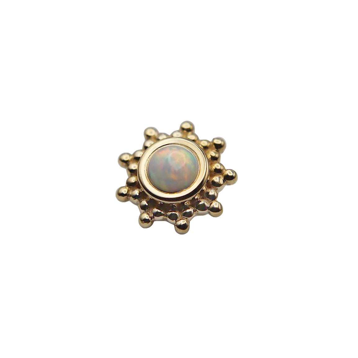 Gold sun-shaped stud with a central synthetic white opal gemstone on a white background