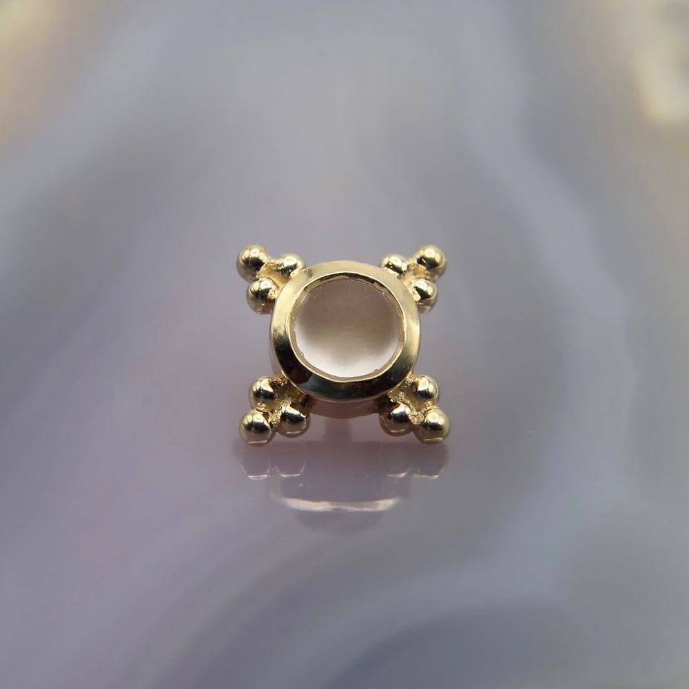 
                  
                    BVLA's "Mini Kandy" in 14k Yellow gold with a Sandblasted Rose Quartz laying on top of a purple background
                  
                