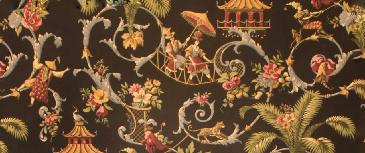 The wallpaper from Ahimsa Piercing Studio, black with filagree and flowers as well as a dog in human clothing and two people walking across a rope bridge holding an umbrella