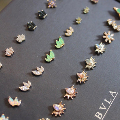 BVLA Dark Navy Colored Jewelry display featuring an assortment of BVLA jewelry in 14k Yellow, Rose and White gold with gems including Diamond, Chrysoprase, White Opals, London blue topaz, Oregon Sunstone, Rainbow moonstone and Peridot.