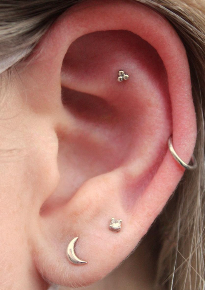 
                  
                    Left ear featuring a 14k White gold BVLA "Tri Bead Cluster" in a flat piercing along with an assortment of other gold jewelry
                  
                
