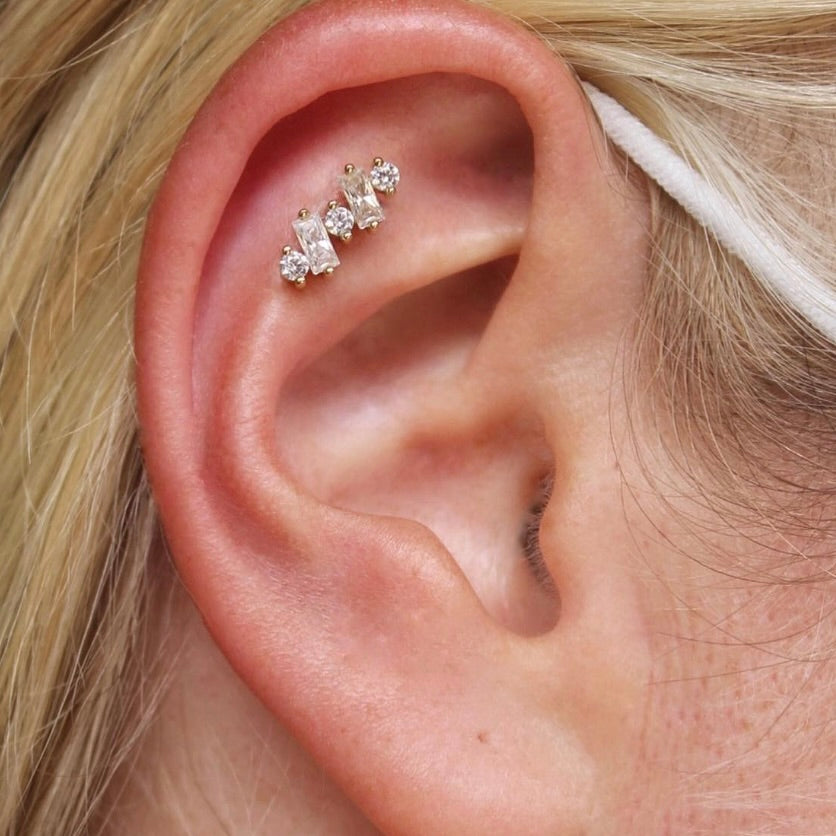 
                  
                    Right ear featuring BVLA's "Divina" in 14k Yellow gold with CZ in a flat piercing
                  
                