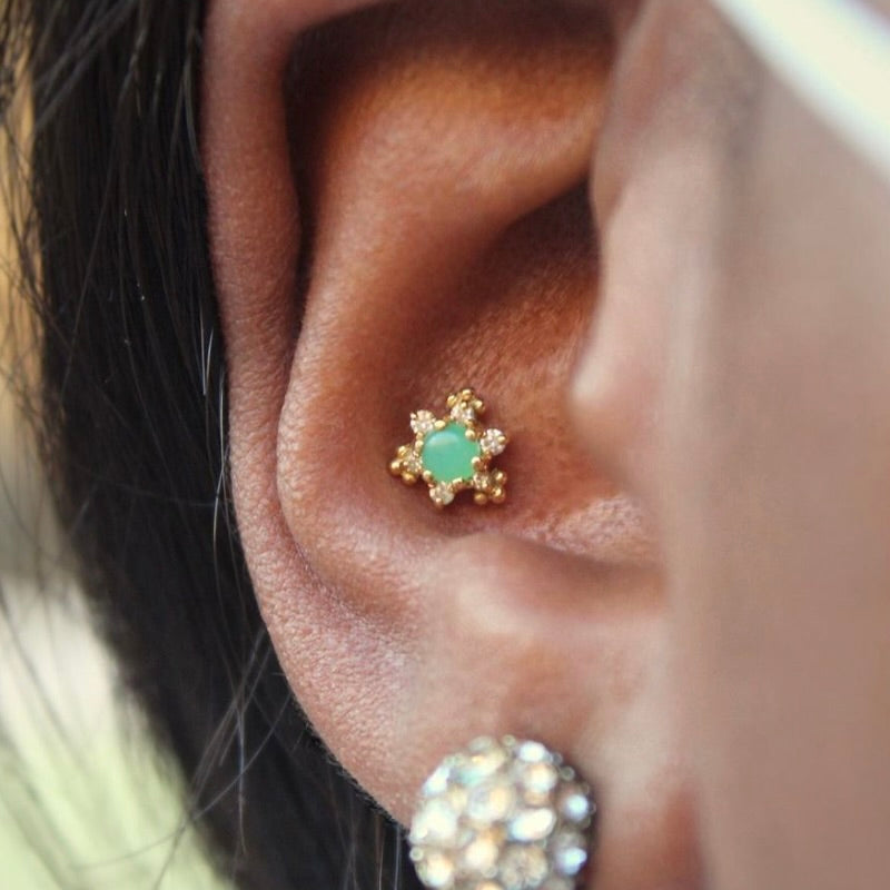 
                  
                    Right ear with BVLA's "Bayle" in 14k Yellow gold with a Chrysoprase Center and diamond accents in a conch piercing
                  
                