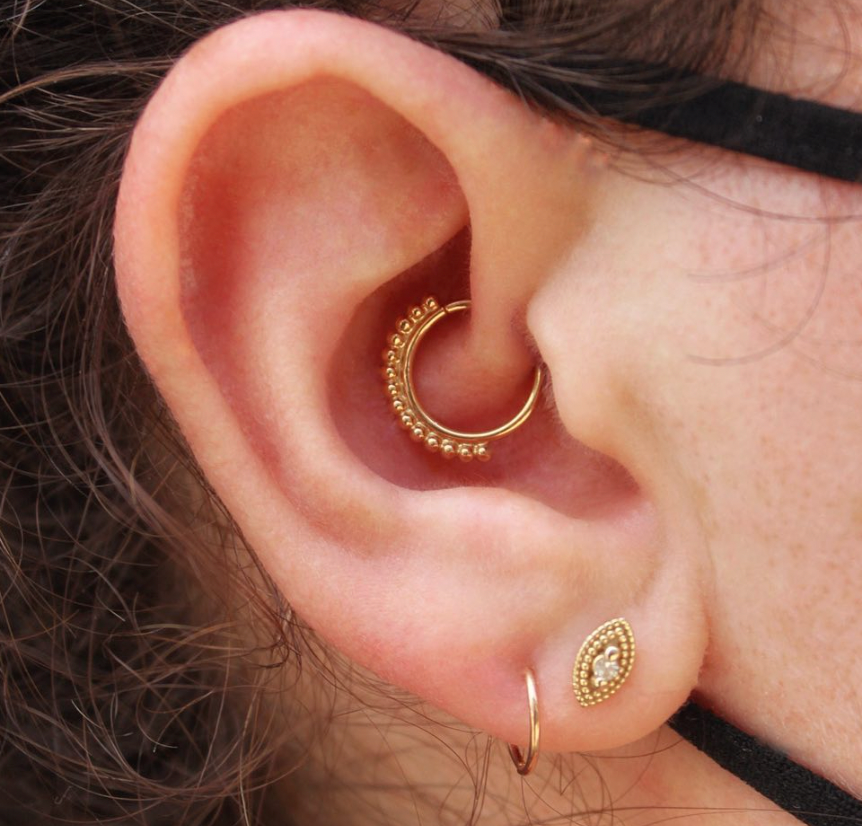 Right ear featuring a BVLA "Latchmi" in 14k Yellow gold in a daith piercing